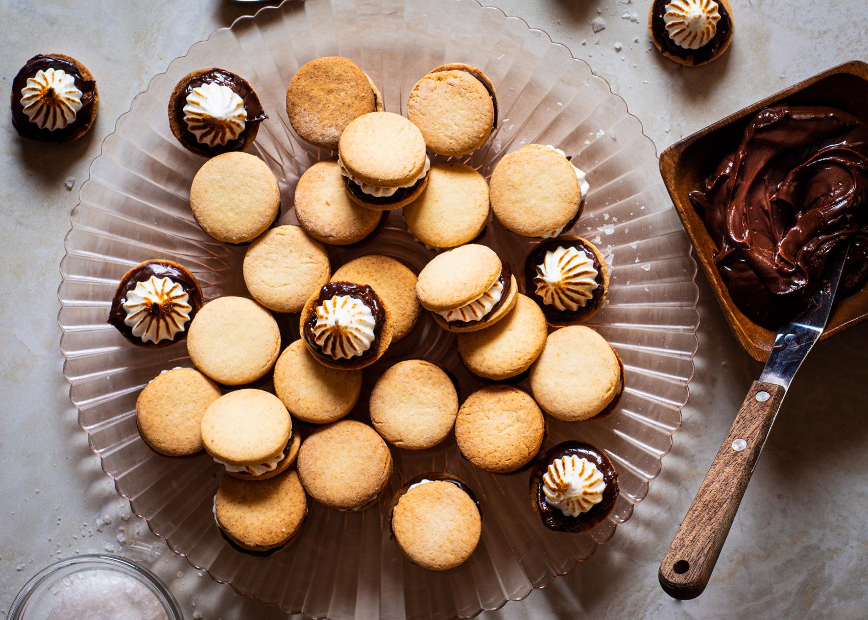 alfajores being assembled with rhubarb filling