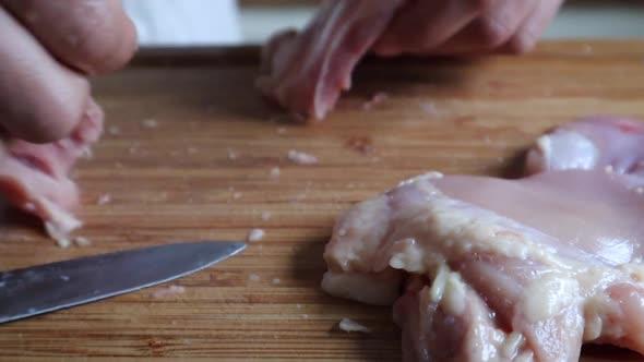 close up of chicken being cut on a cutting board