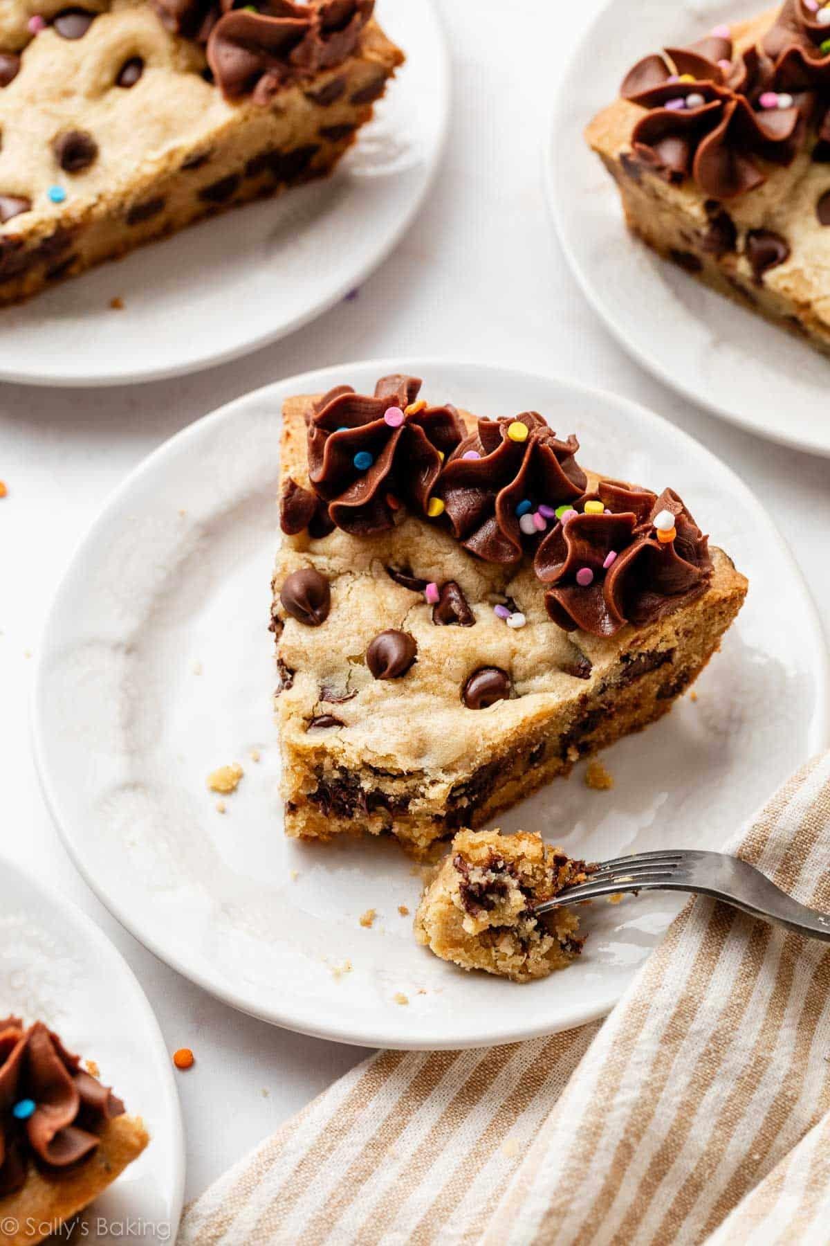 close-up of a slice being cut from a cookie cake, showing the soft, chewy interior