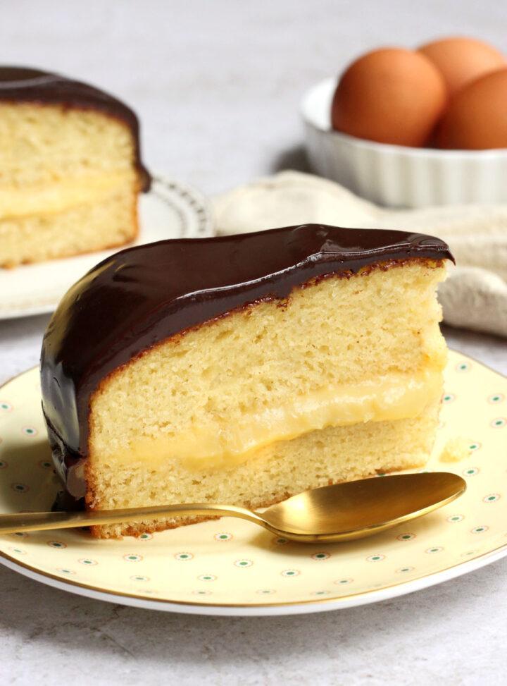 slice of Boston cream chocolate layer cake on a plate