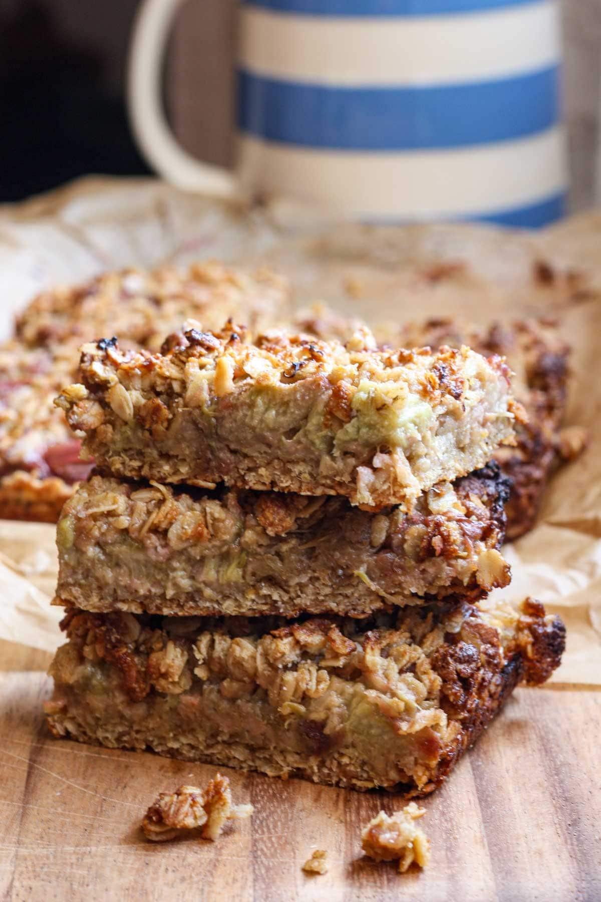 Rhubarb bars with peanut milk on a rustic wooden surface