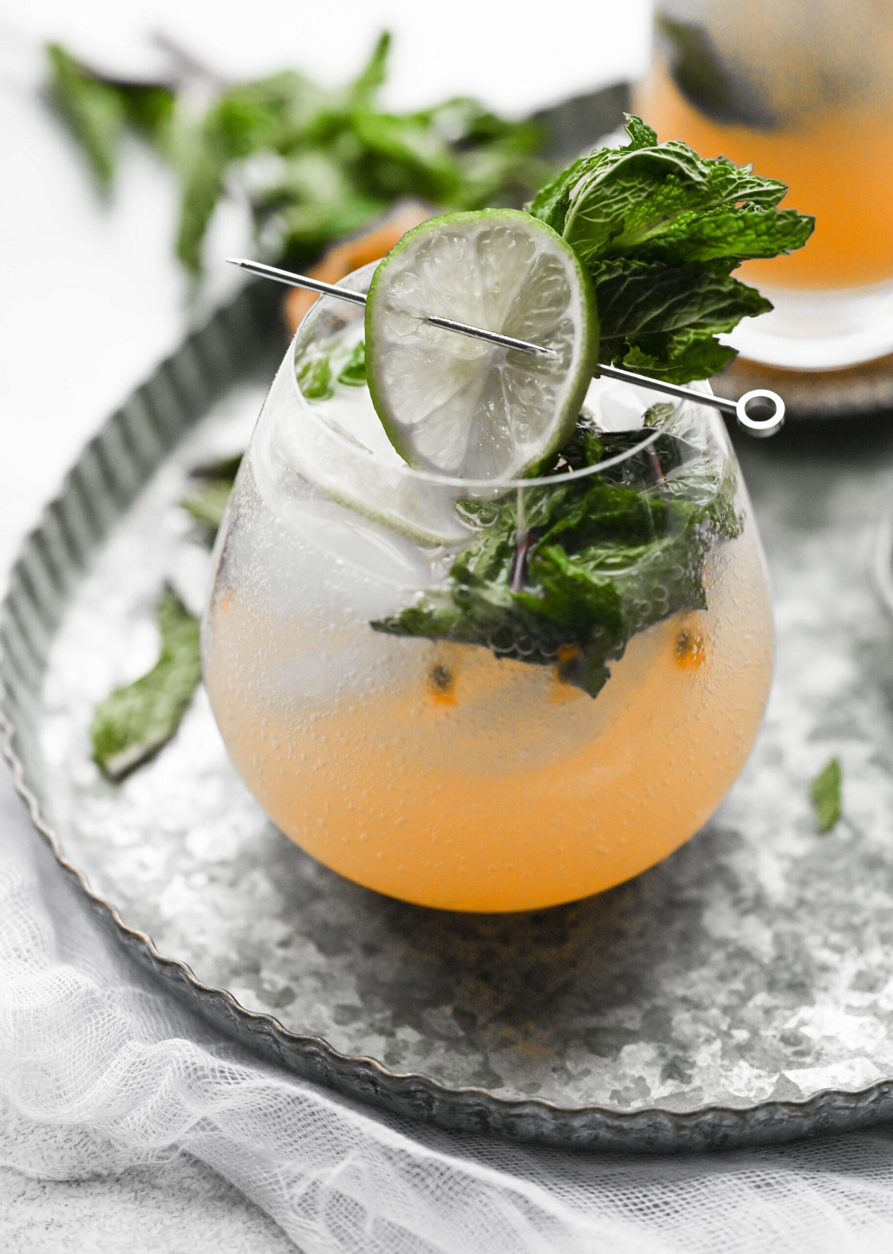 passionfruit ginger virgin mojito in a glass with lime and mint garnish