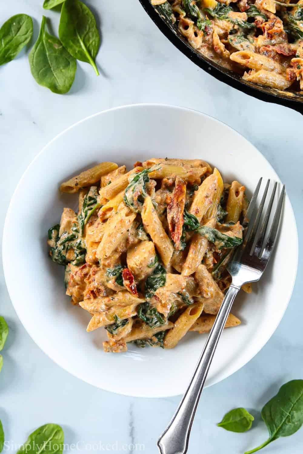 Creamy Tuscan Chicken Pasta Bake with golden brown crust