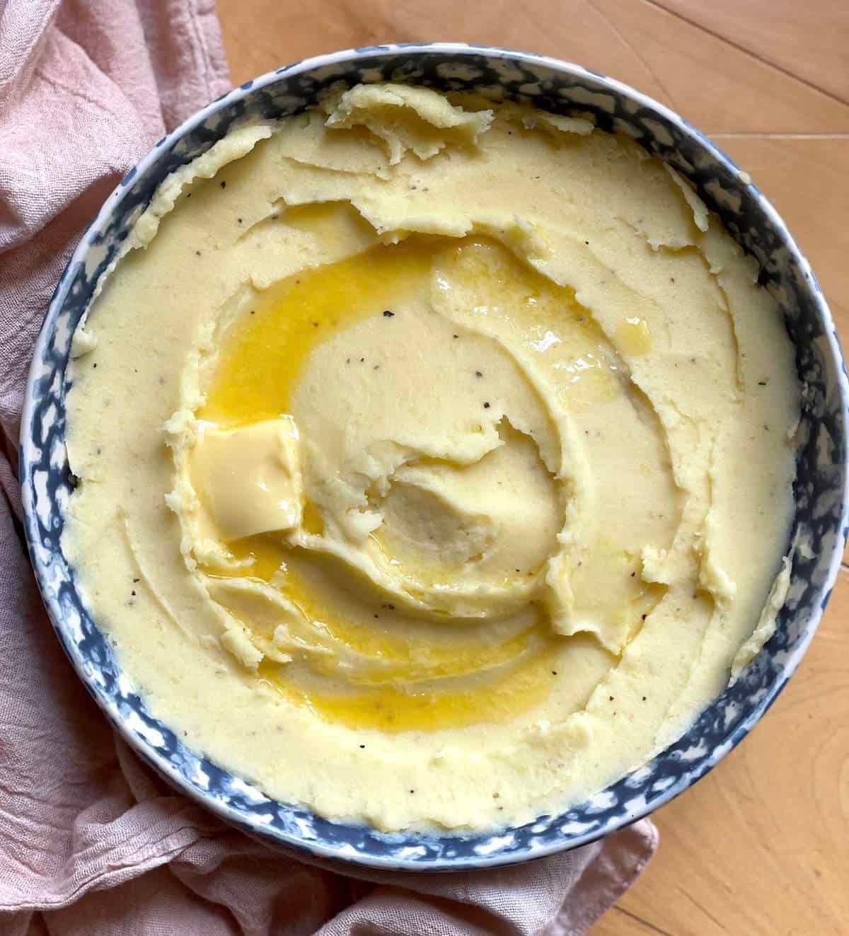 Close-up shot of mashed potatoes with a pat of melting butter
