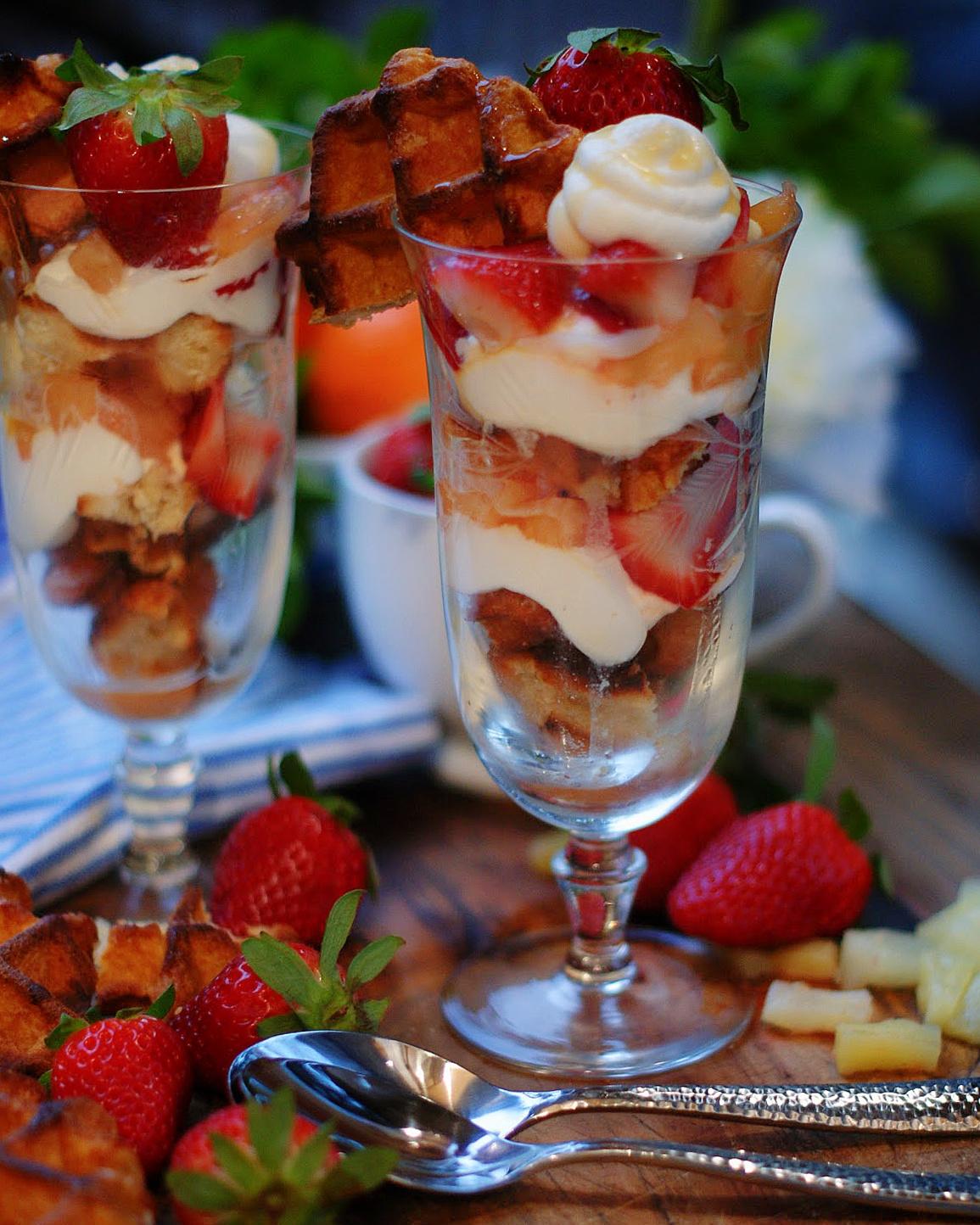 Close-up of stacked berry waffle parfaits in glass cups