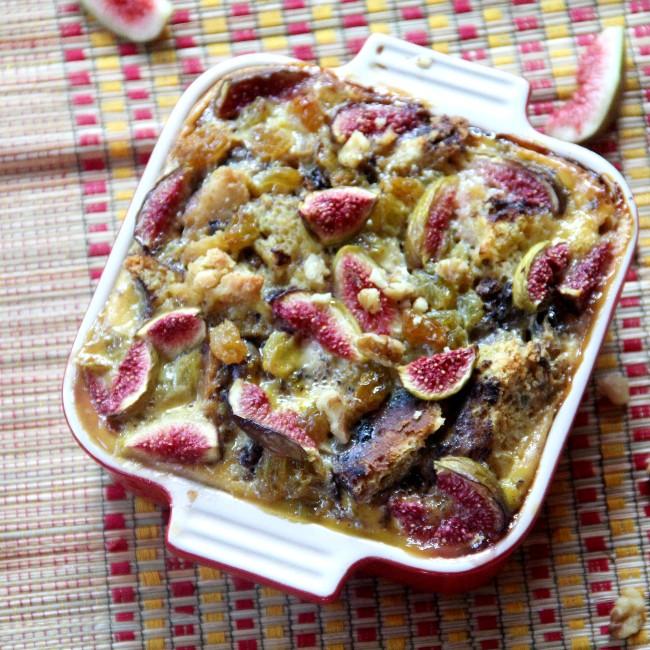 Port fig walnut bread pudding served in a baking dish with a scoop taken out