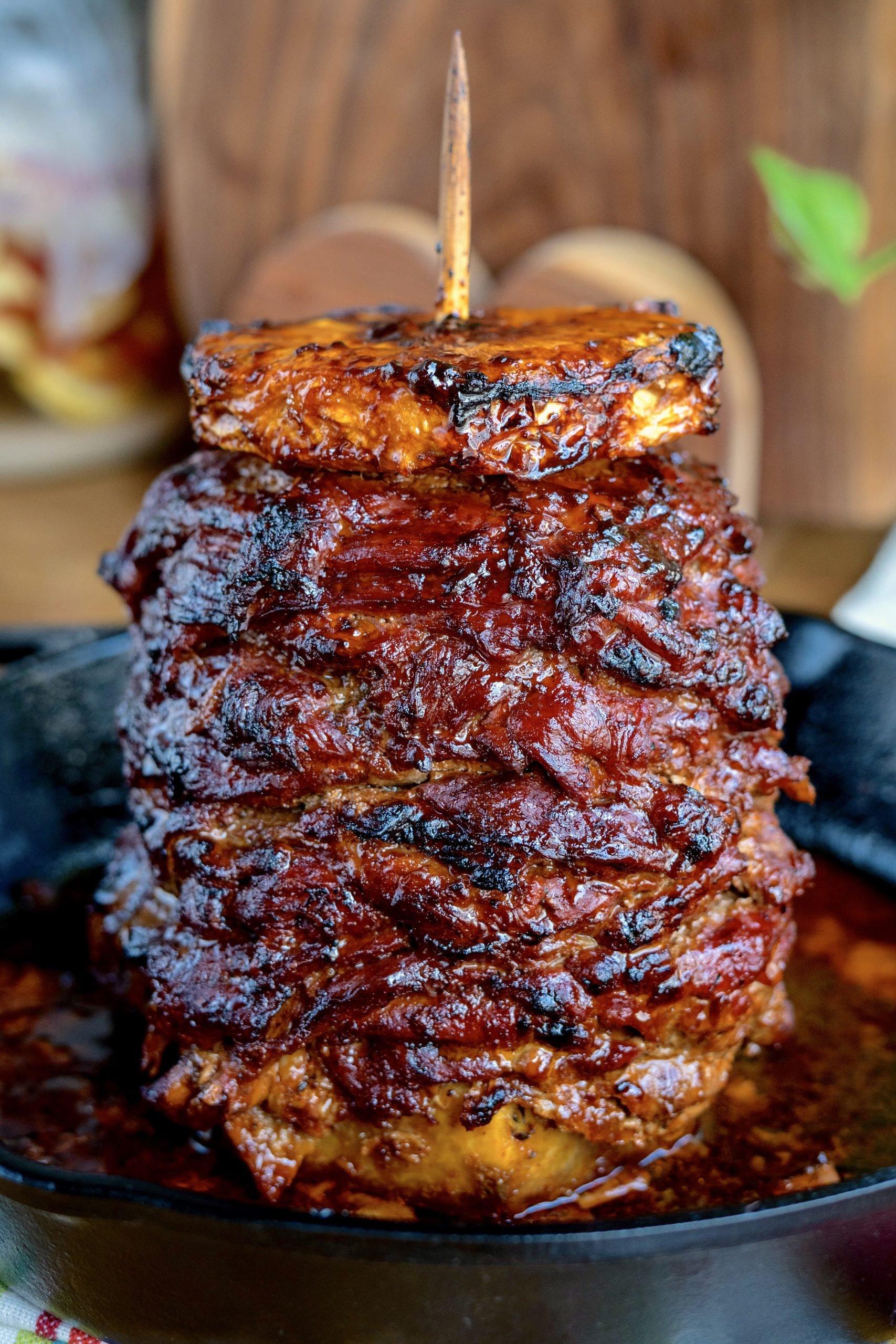 close-up shot of al pastor meat cooking in a skillet