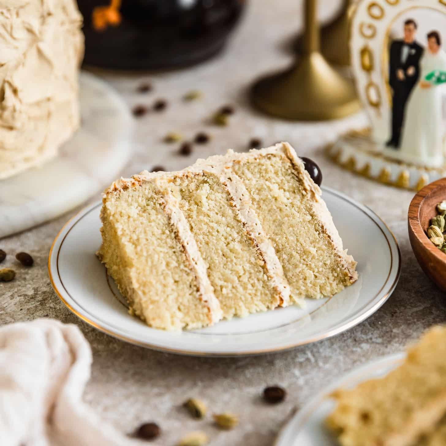 a slice of vanilla cardamom birthday cake on a plate
