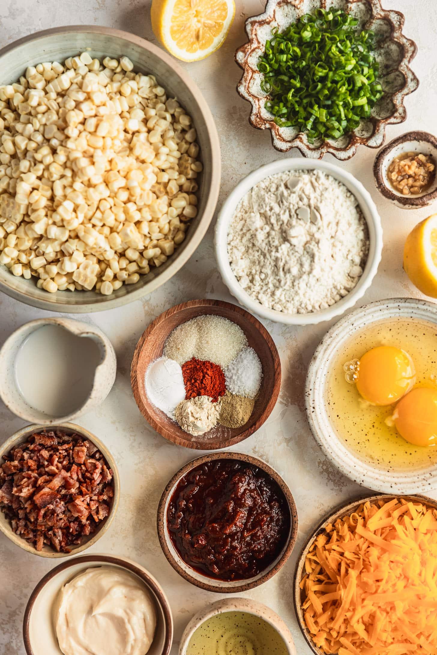 ingredients for corn fritters laid out on a wooden table