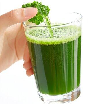 a vibrant green juice being poured into a clear glass, showcasing its texture and color