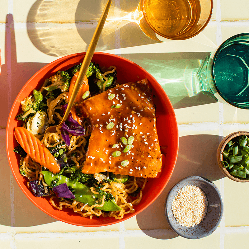 a bowl of teriyaki glazed carrot fries with chopsticks