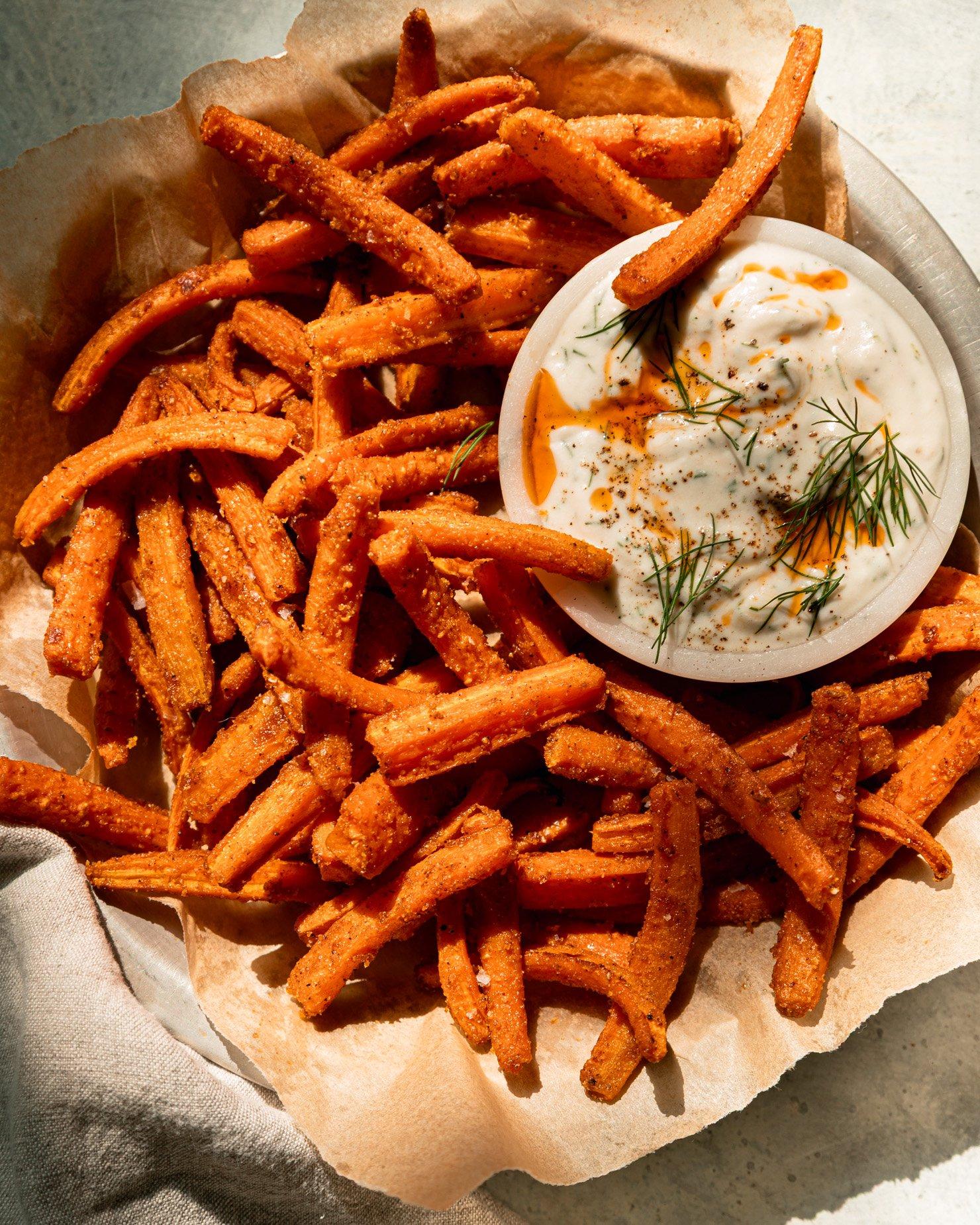 close up shot of roasted carrot fries with herbs and garlic