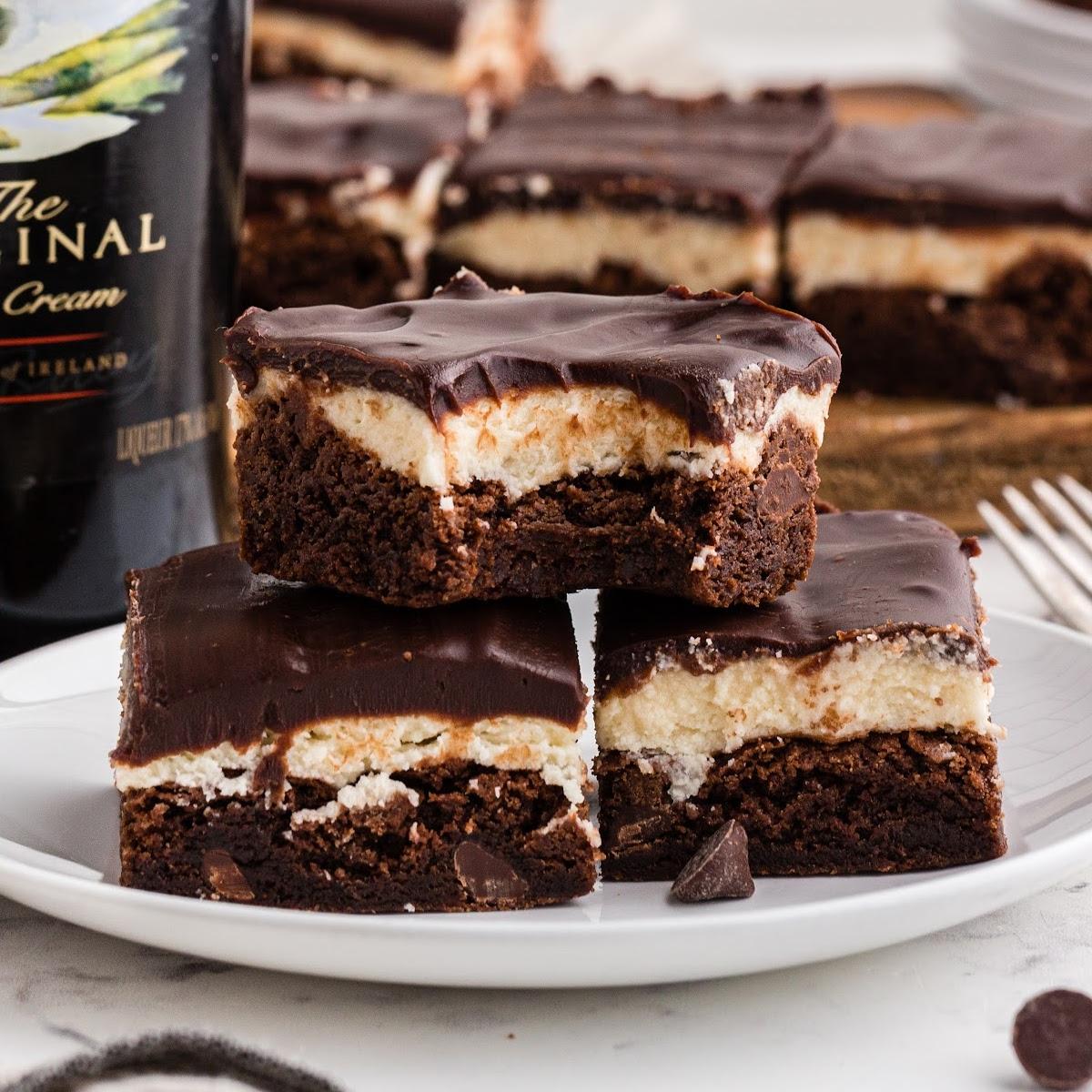 a stack of Baileys brownies, garnished with cocoa powder and fresh berries