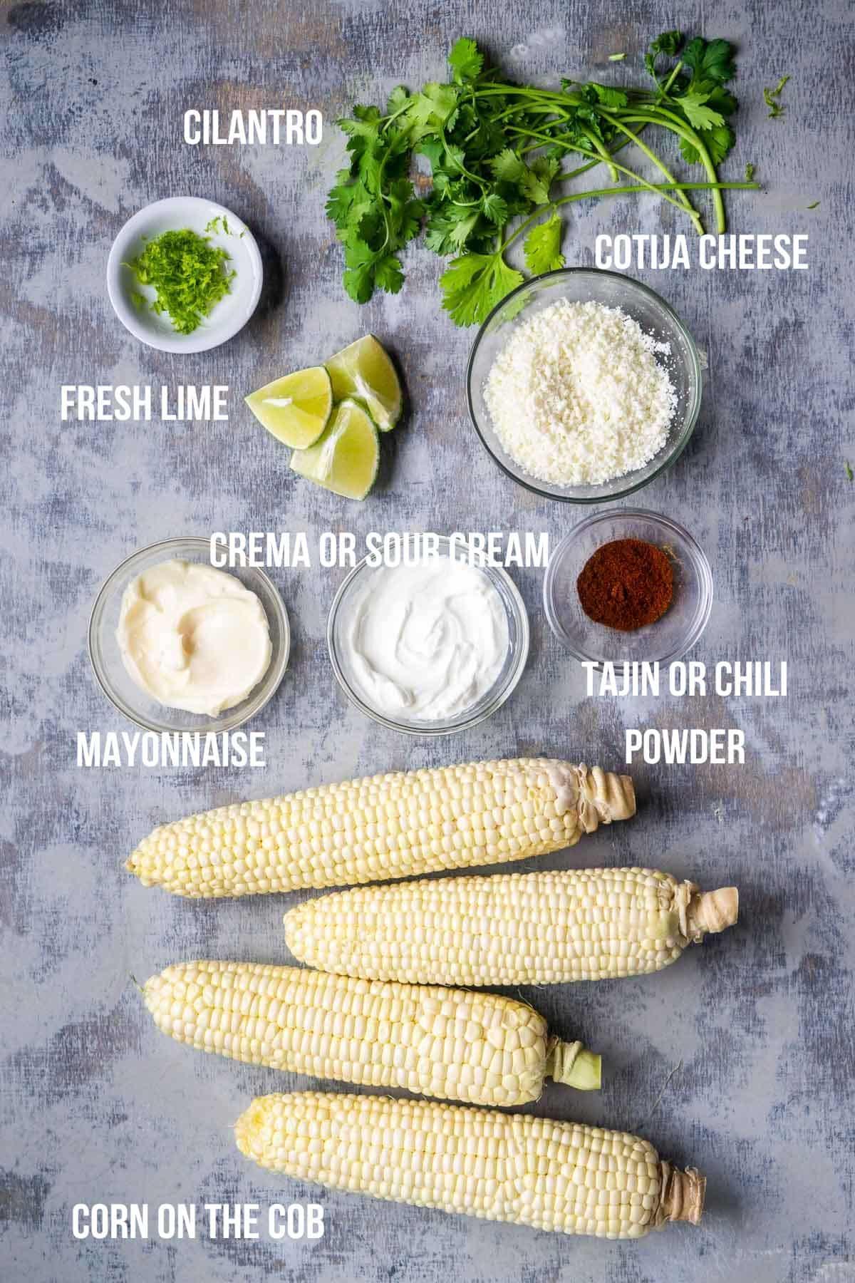 Ingredients for elote mousse arranged on a wooden table