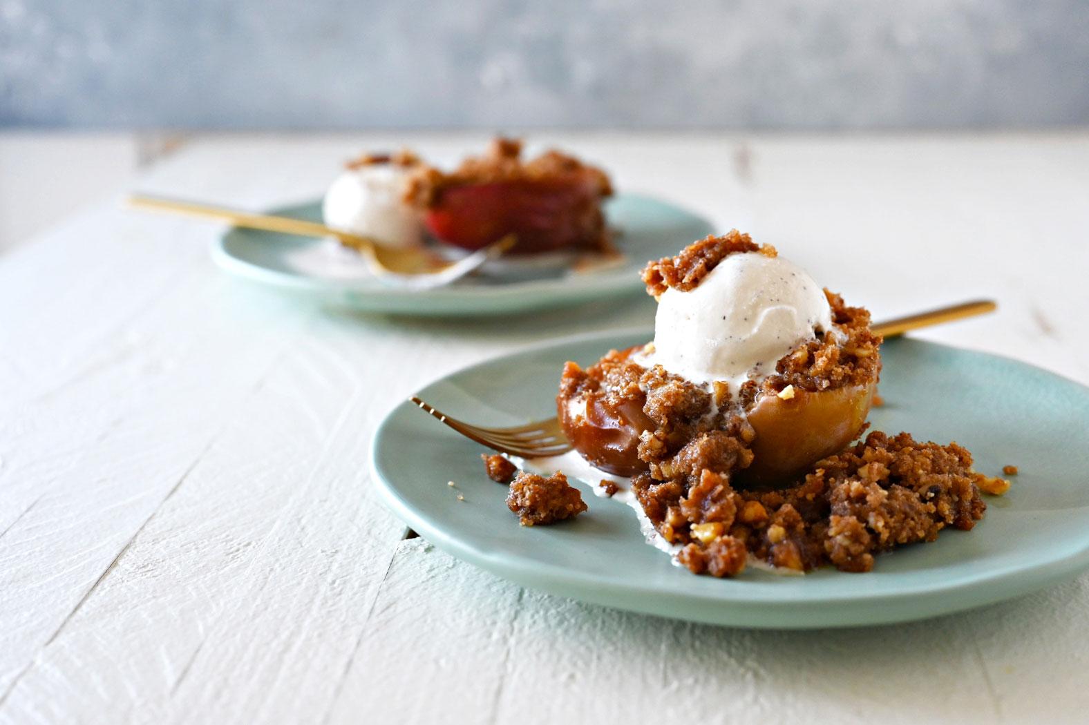 Ingredients for baked apples with walnut streusel laid out on a wooden table