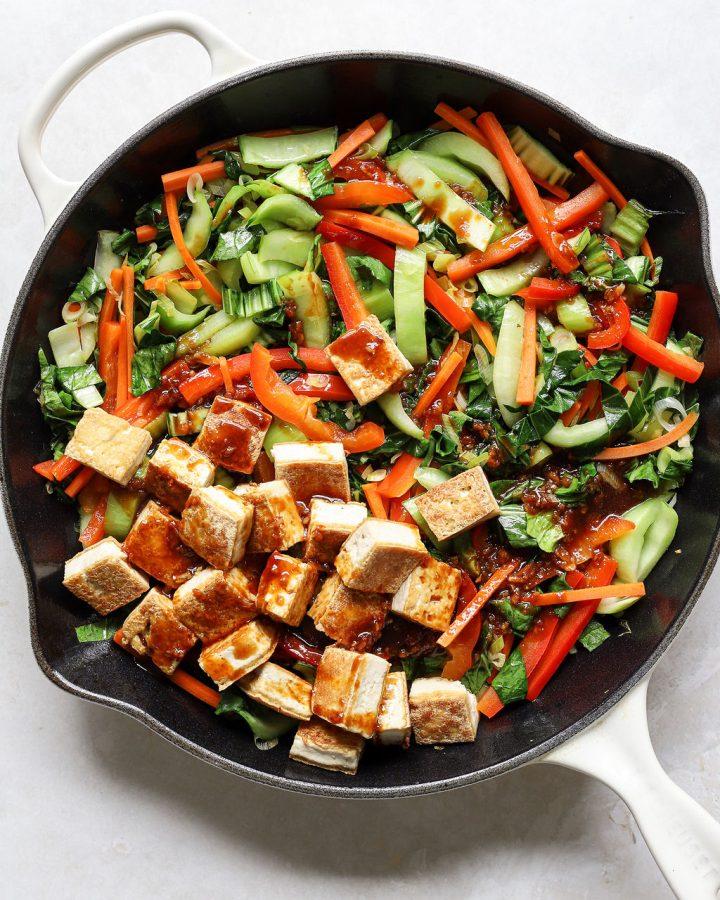 overhead shot of a wok filled with tofu and bok choy stir-fry being cooked