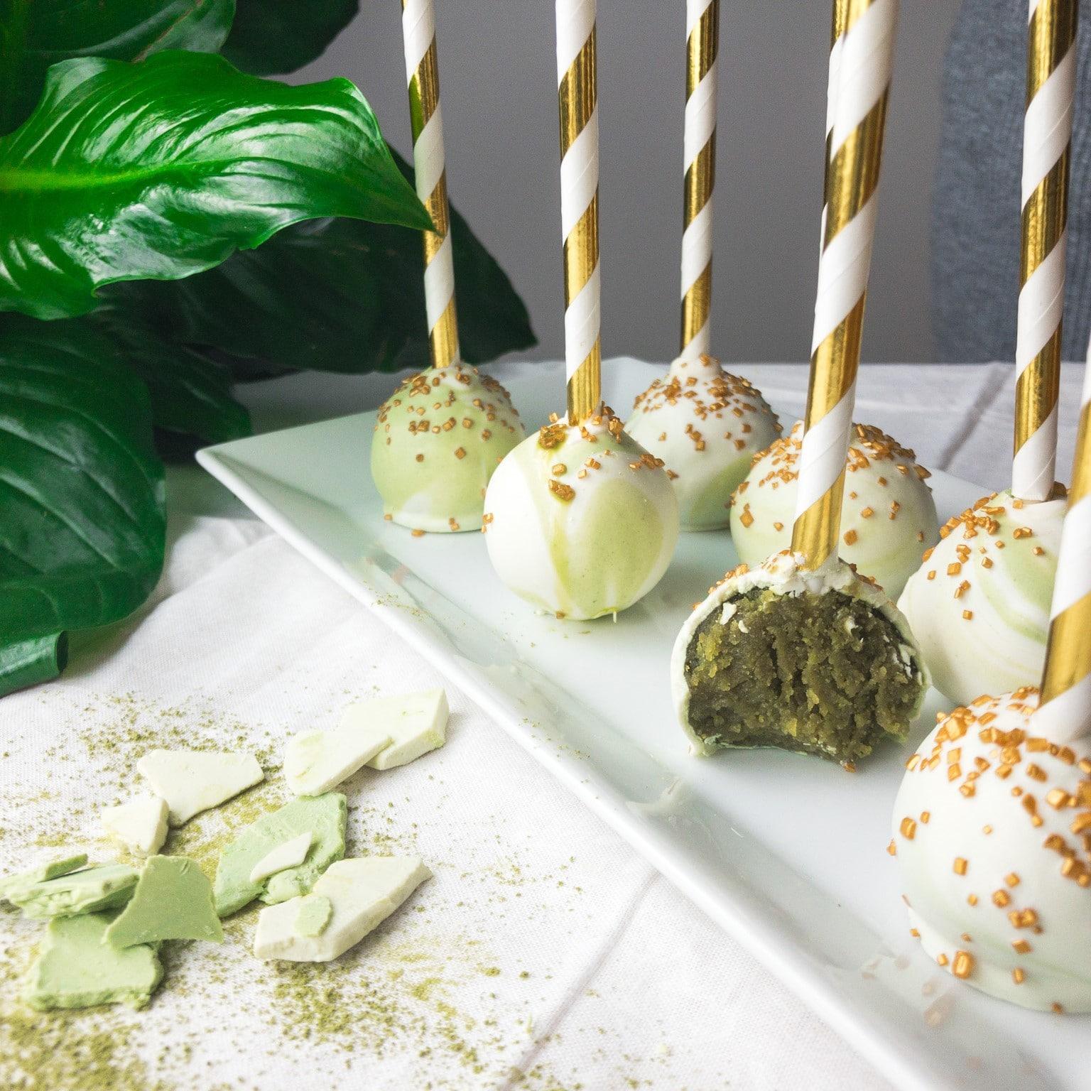 Matcha white chocolate cake pops arranged on a display stand