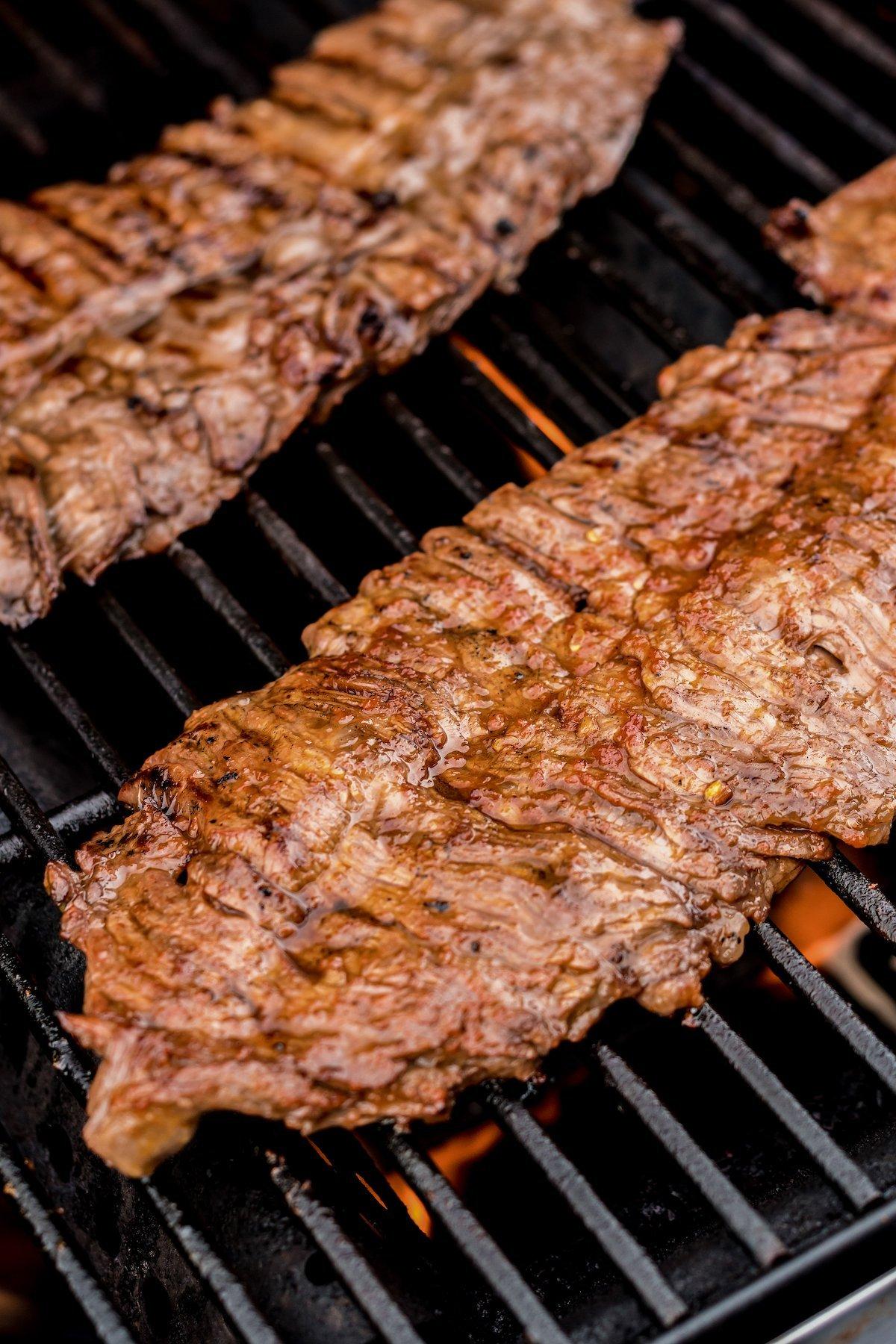 close up of a juicy flank steak being grilled