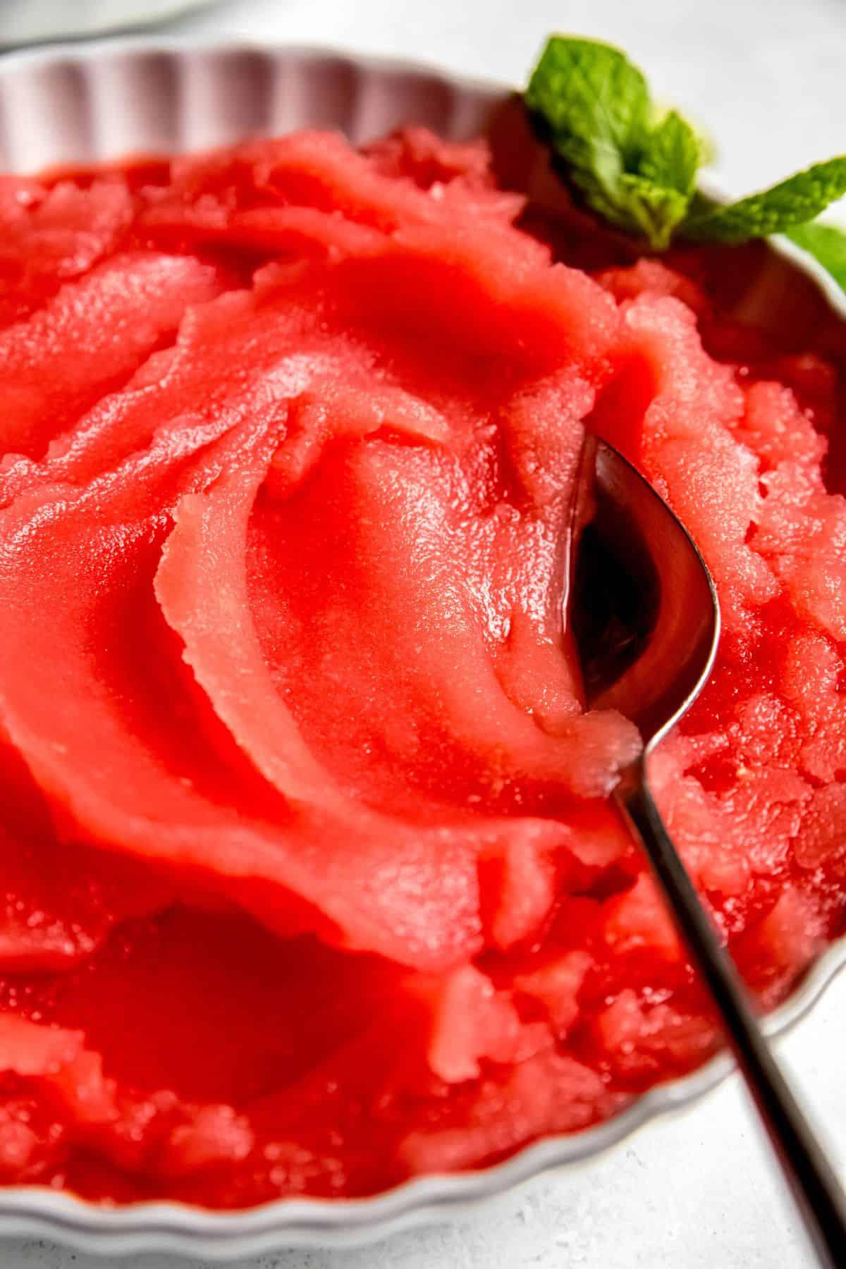close-up of a spoon scooping summer sorbet from a bowl