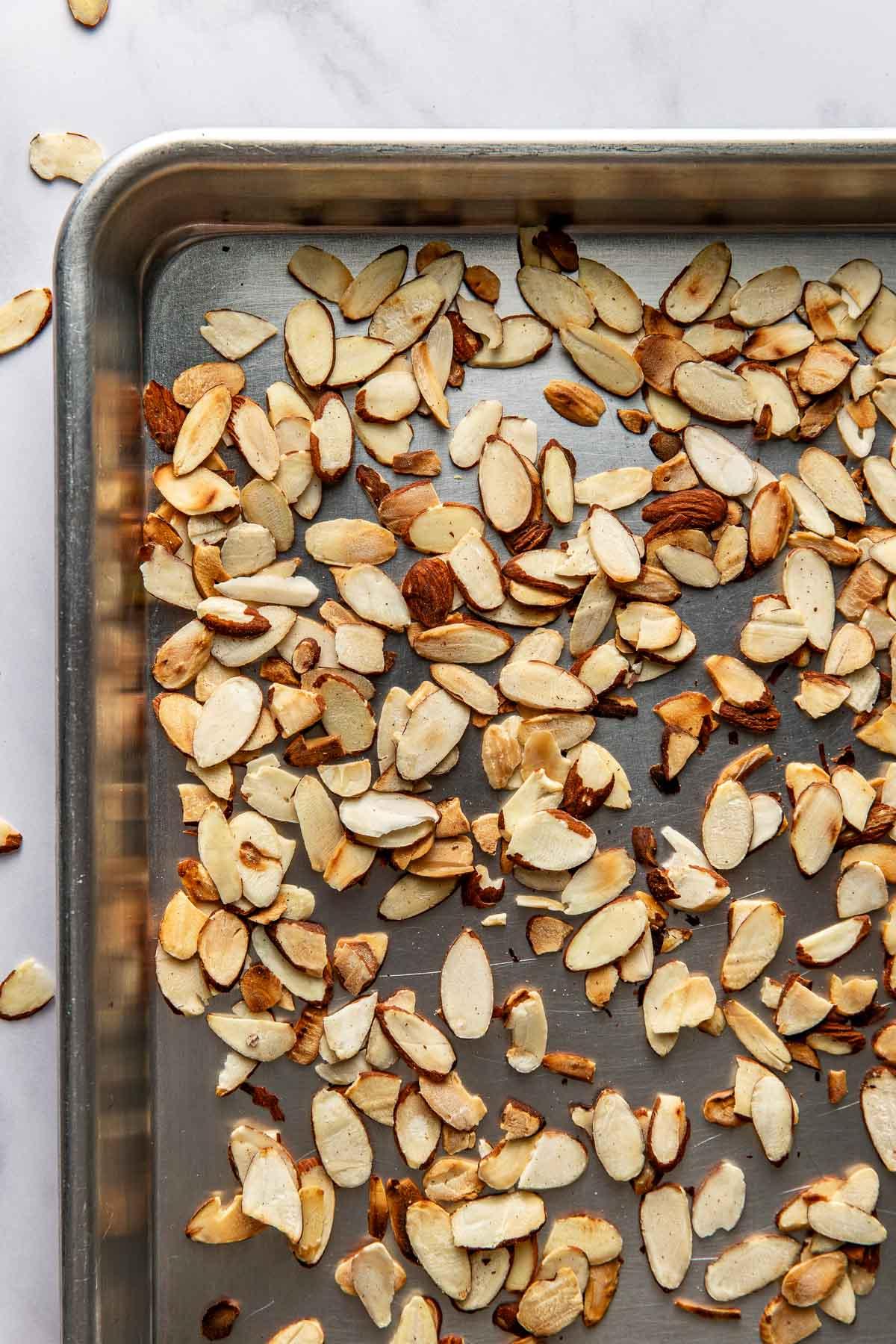 Close-up of toasted almonds on a baking sheet, golden and fragrant