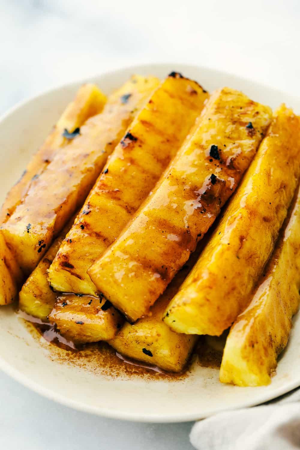 close-up shot of grilled pineapple with cinnamon and sugar, showing caramelized texture
