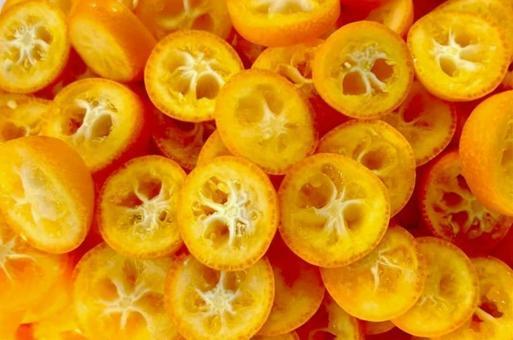 Close-up shot of a kumquat being sliced