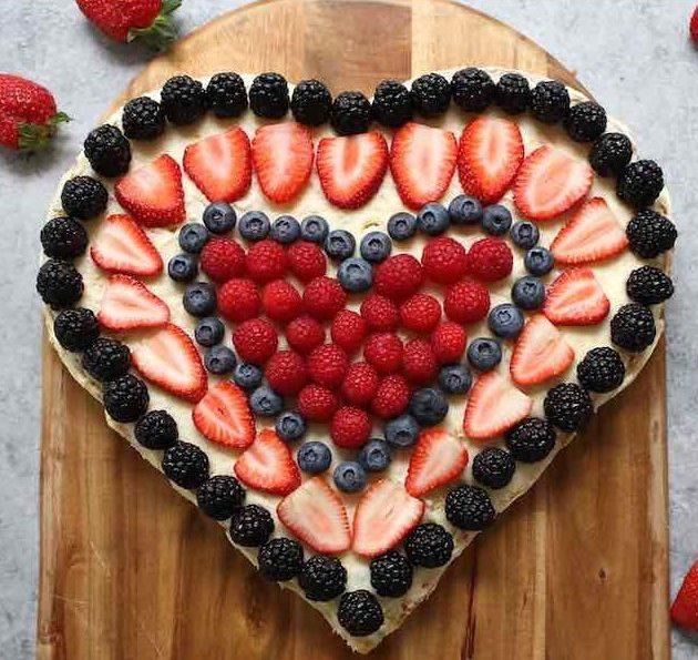overhead view of the complete Hidden Strawberry Heart Cake with decorative strawberries on top