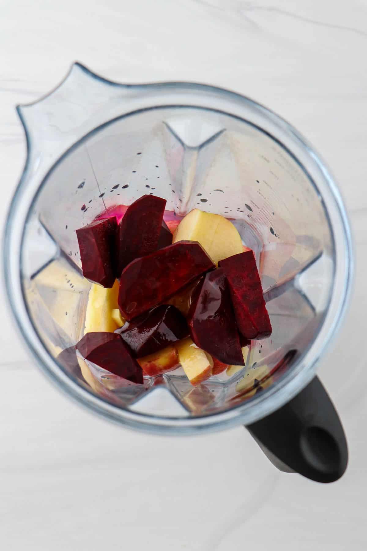 close up of beet juice being poured into a blender