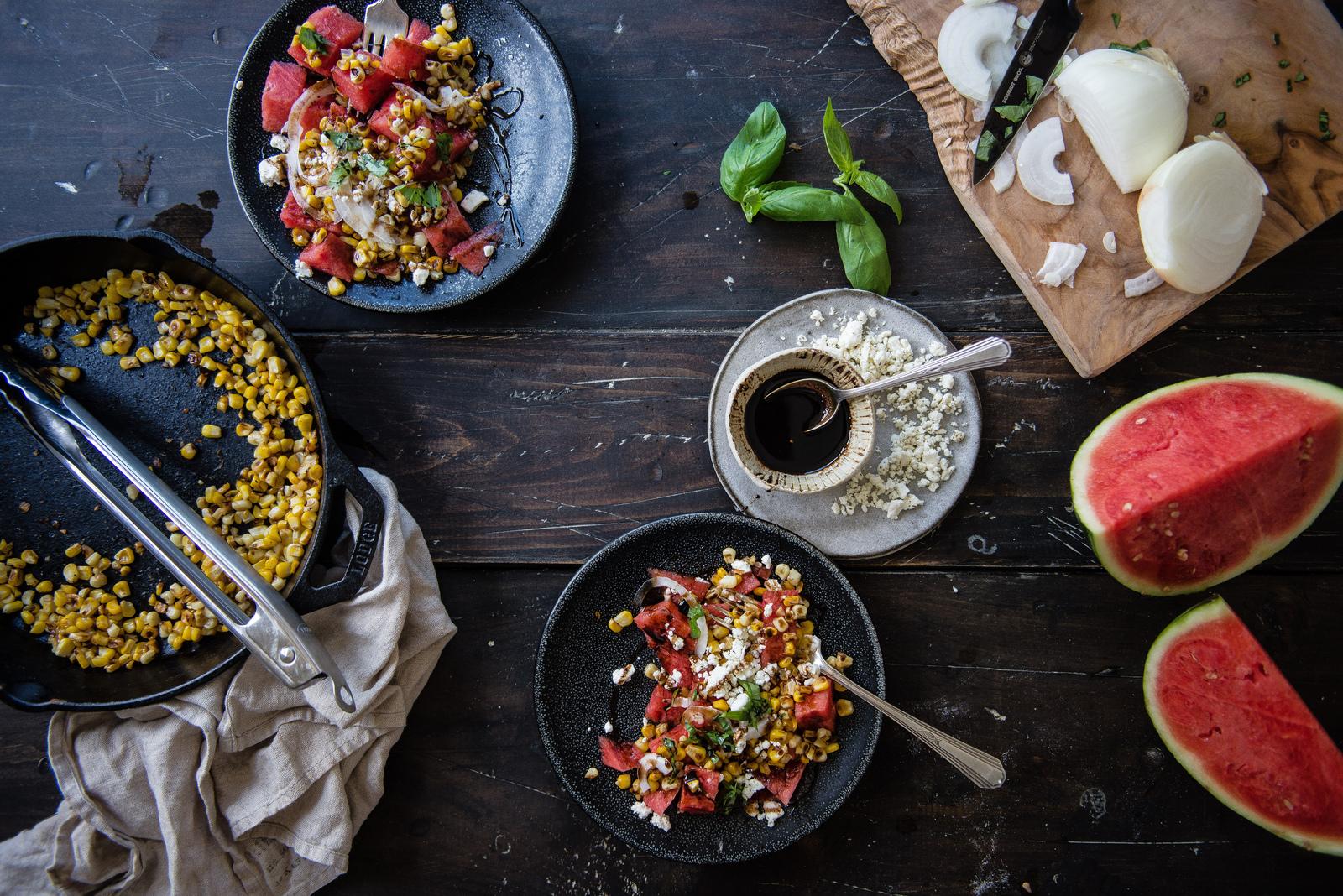 close up shot of Grilled Corn & Watermelon Salad with Mint & Lime in a rustic bowl