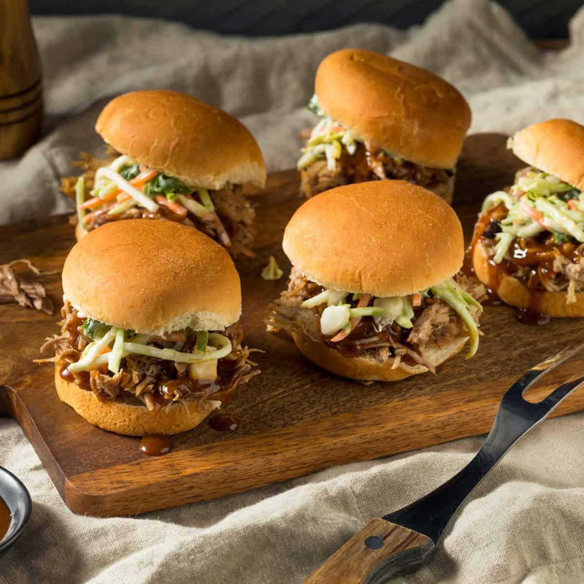 ghost pepper pulled pork sliders on a wooden board