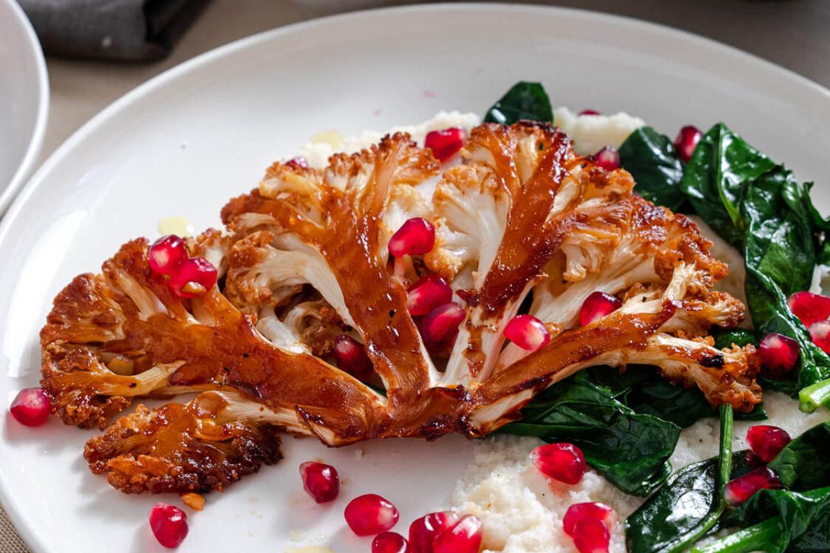honey sriracha cauliflower steaks plated with rice and green onions