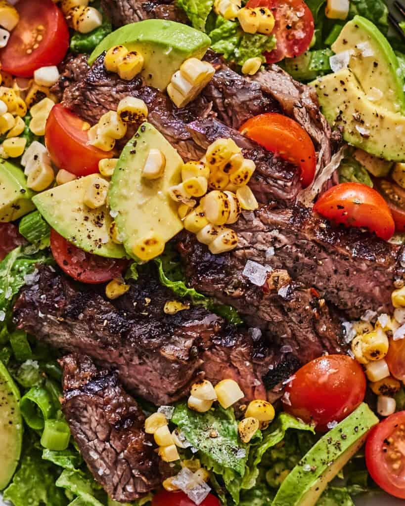 Close-up shot of the steak salad showing the layers of ingredients