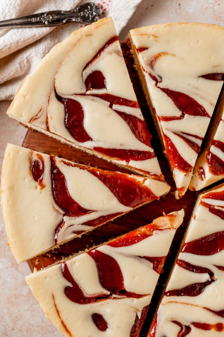 top-down view of a guava cheesecake with guava swirl design