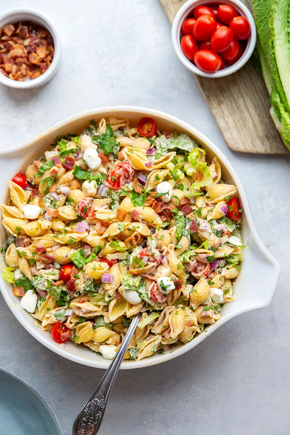 Overhead shot of a colorful BLT pasta salad with chipotle mayo served on a platter