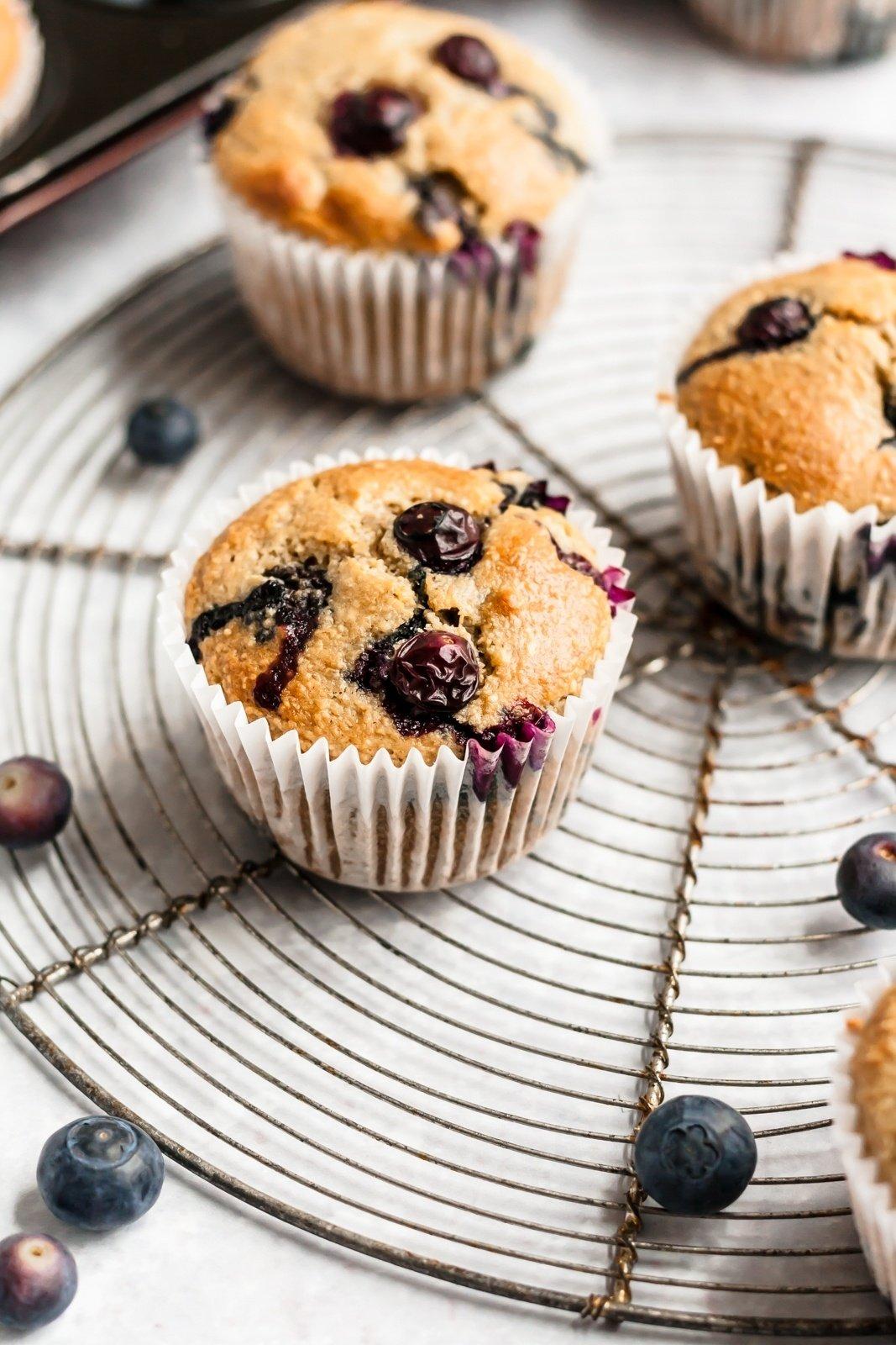 healthy clean eating blueberry oat muffins on a wooden table