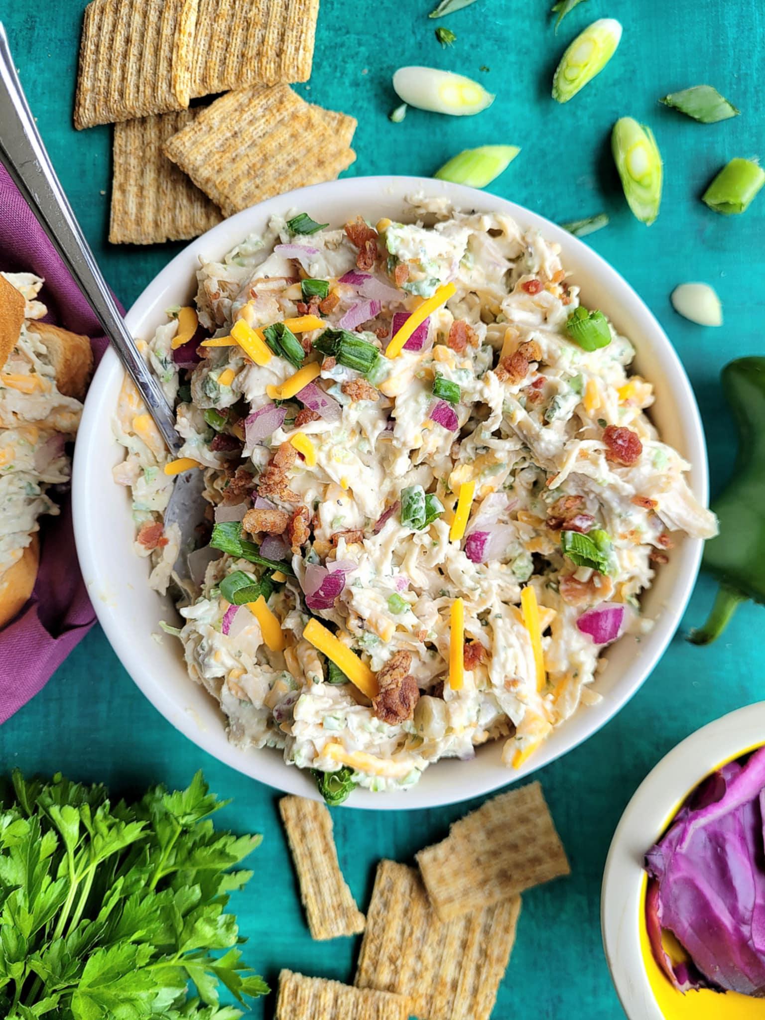 close up shot of Jalapeno Popper Chicken Salad Dip with crackers and vegetables