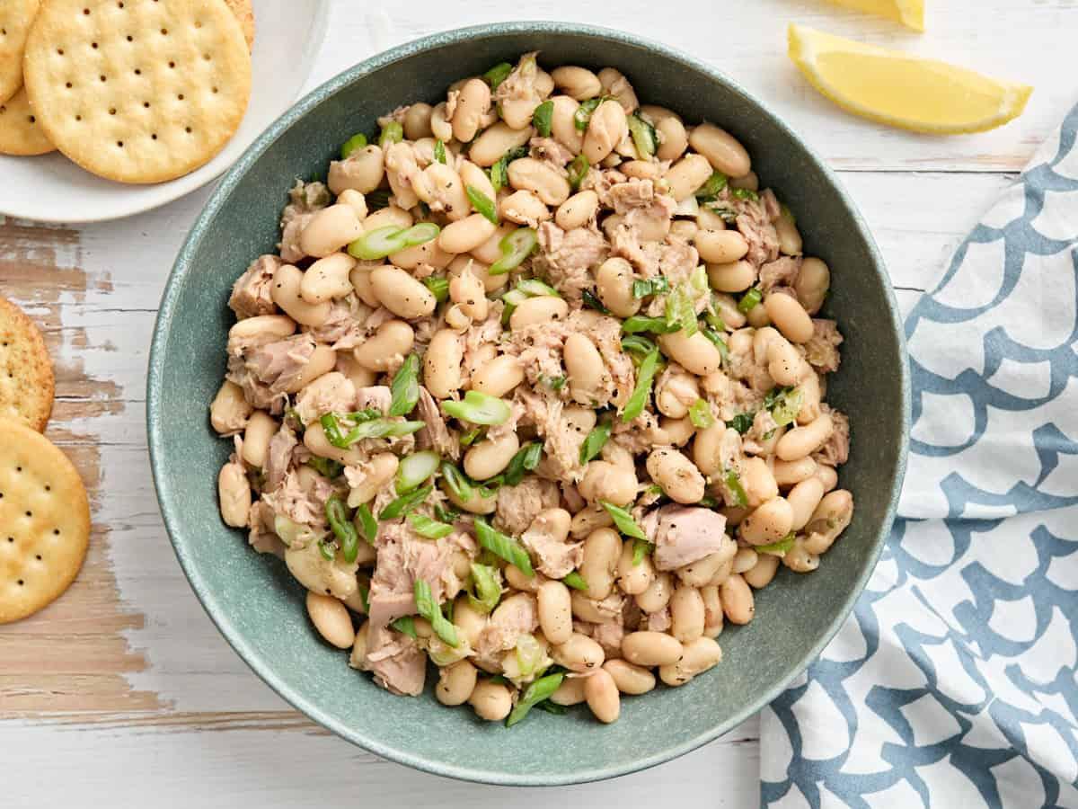overhead shot of white bean and tuna salad ingredients laid out on a wooden table