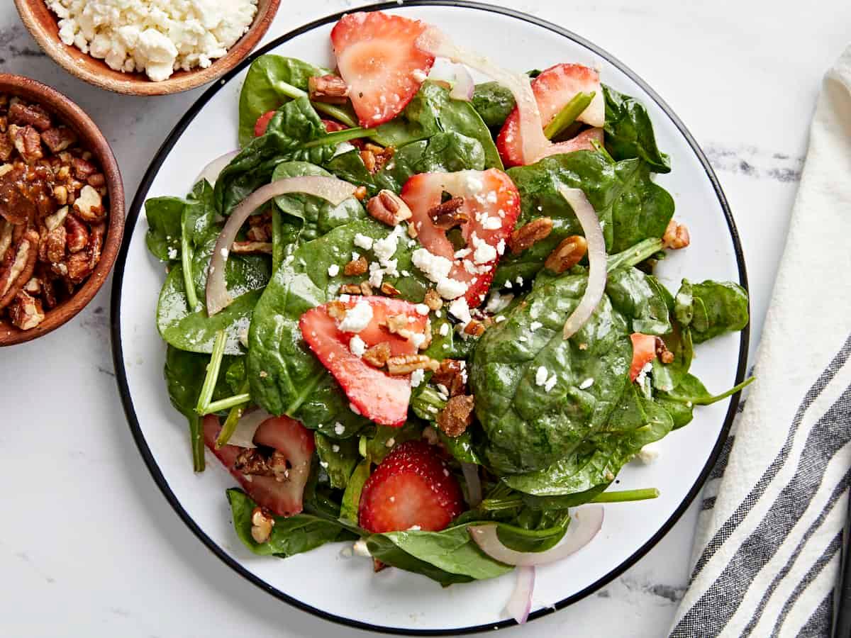 A close-up shot of a vibrant strawberry spinach salad.