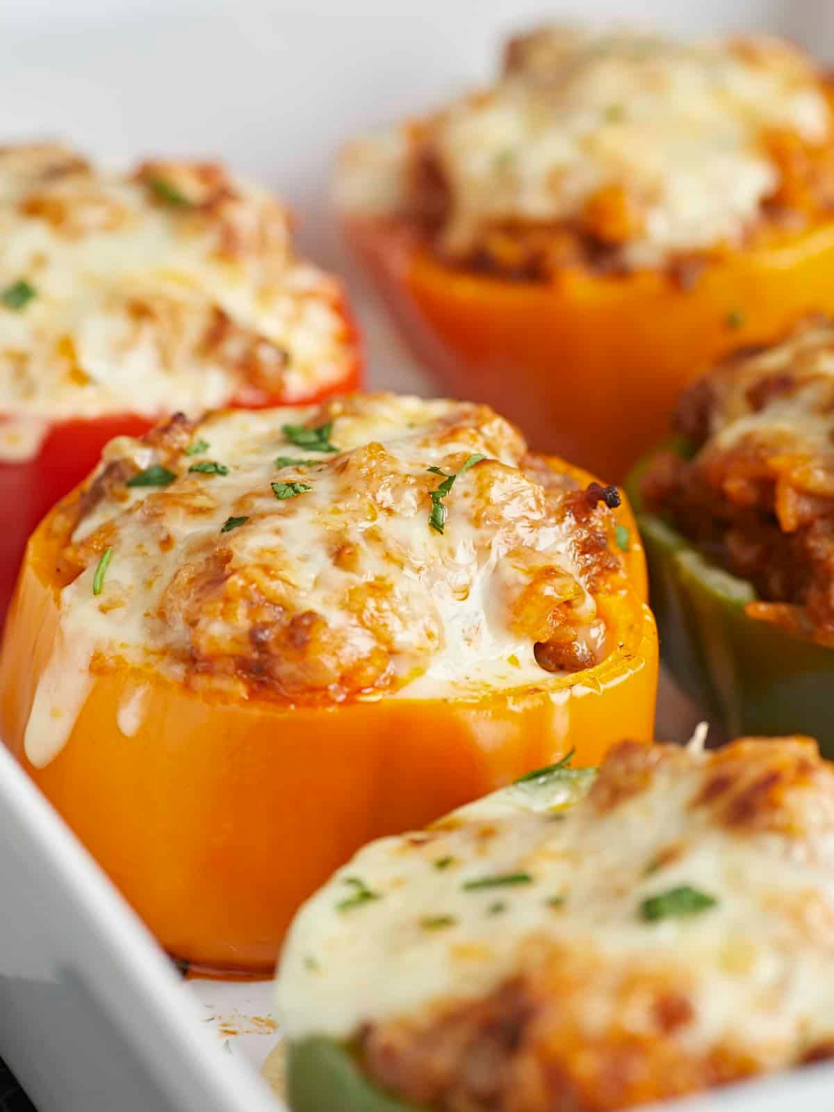 close up of stuffed bell peppers baking