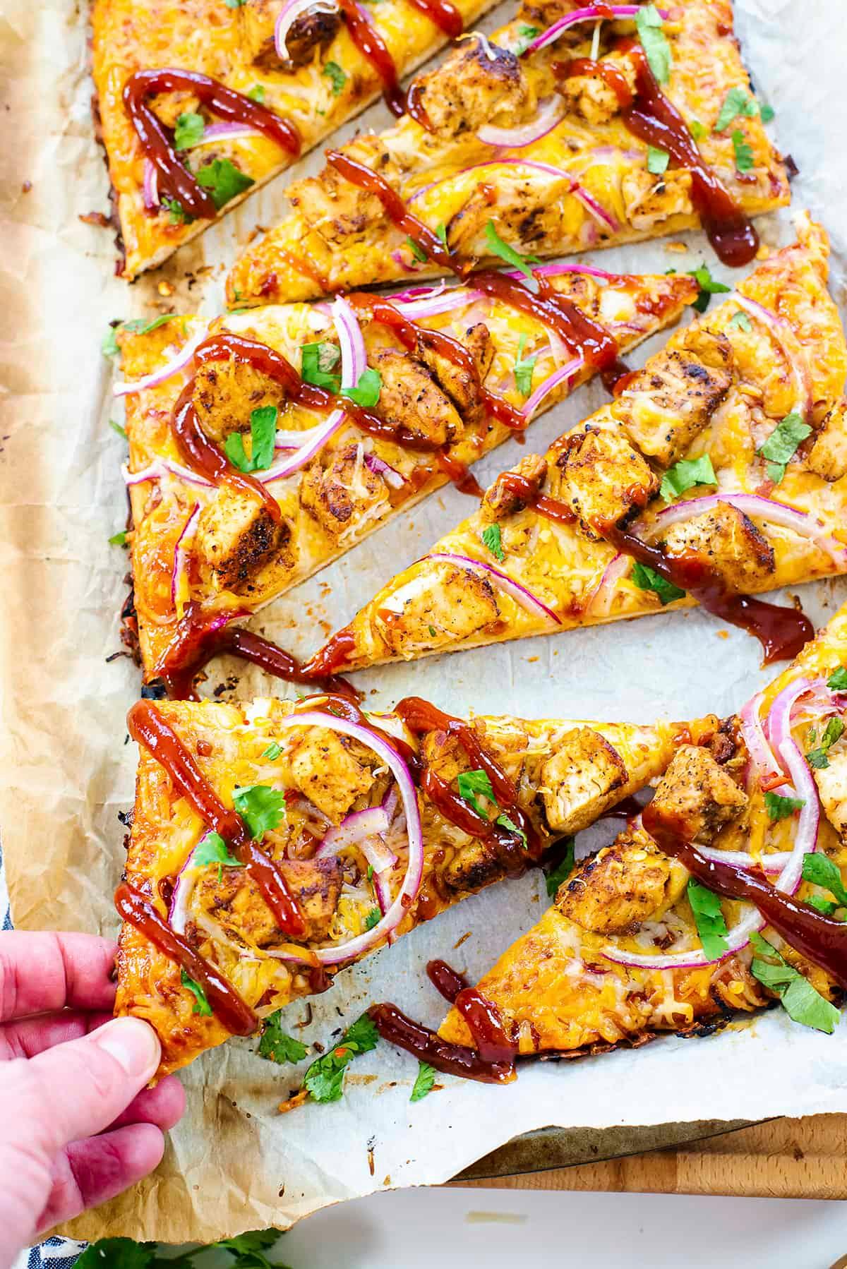 BBQ chicken flatbread on a griddle with a father and child in the background