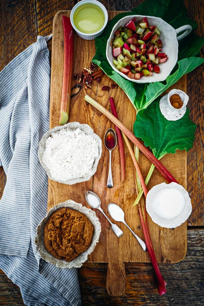 ingredients for rhubarb bread arranged on a wooden table