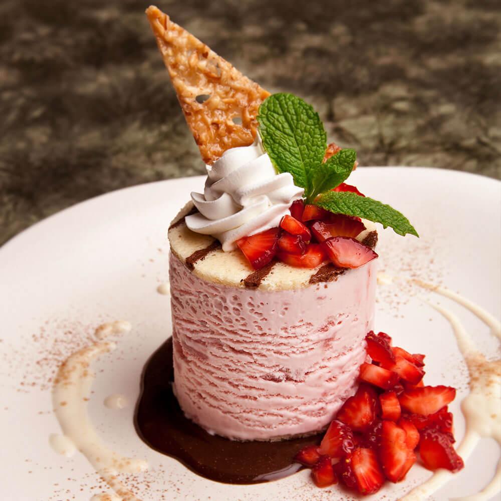 close up of a freshly made rosewater almond ice cream sandwich with visible almond pieces