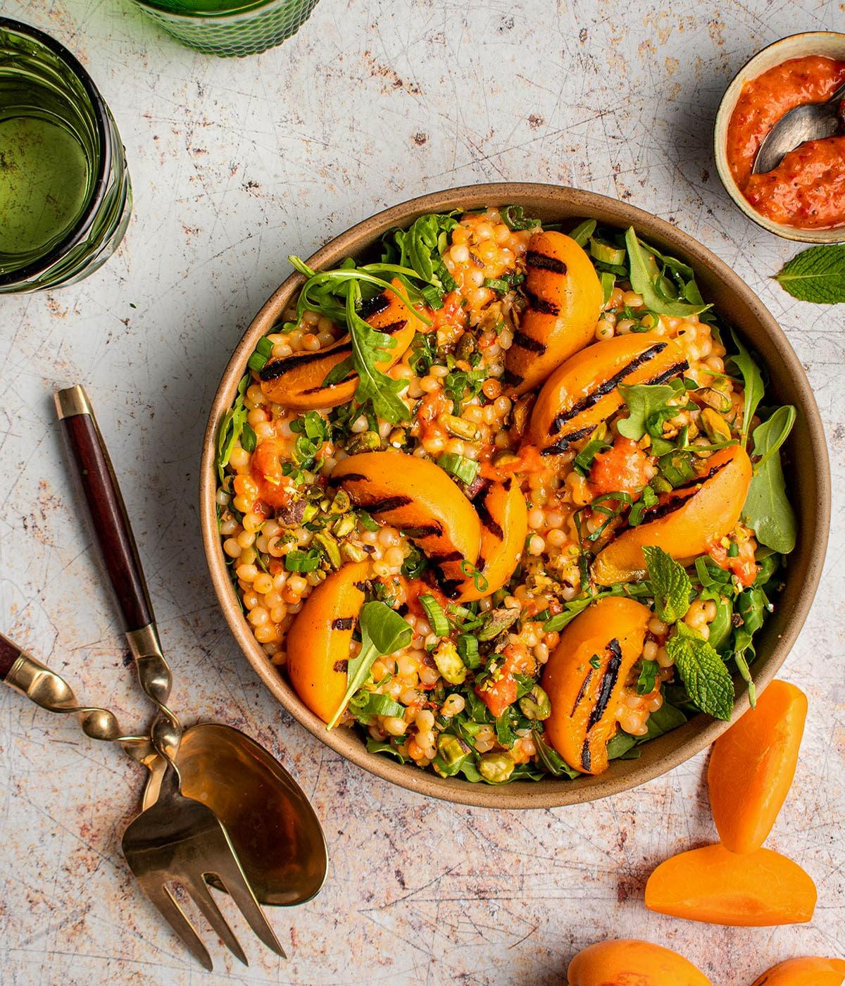 Overhead shot of Couscous Salad with Apricots & Almonds served in a colorful bowl.