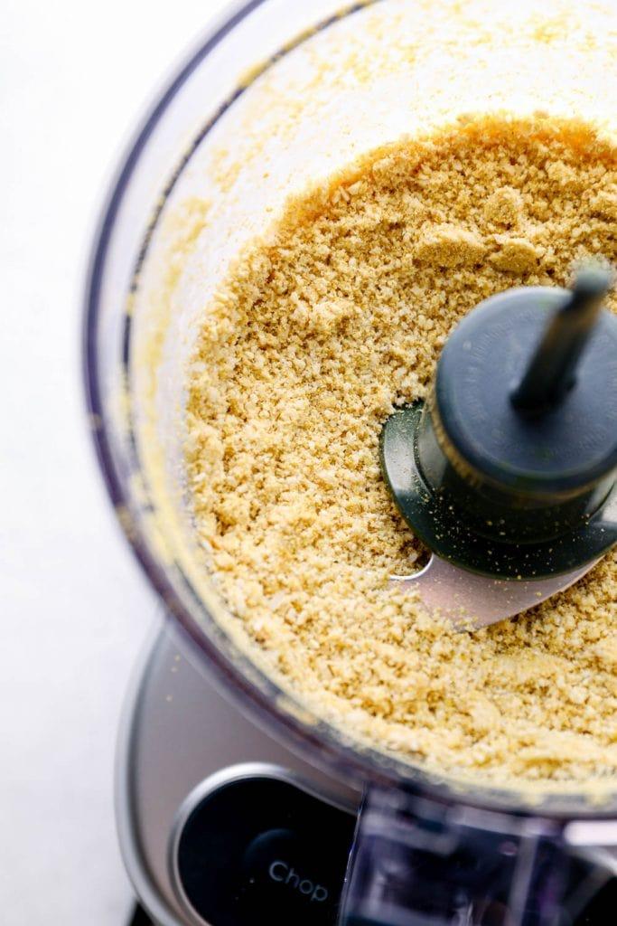 close up shot of vegan parmesan being made in a food processor