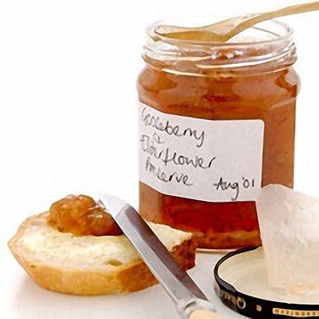 close-up shot of gooseberries and elderflowers on a rustic wooden table