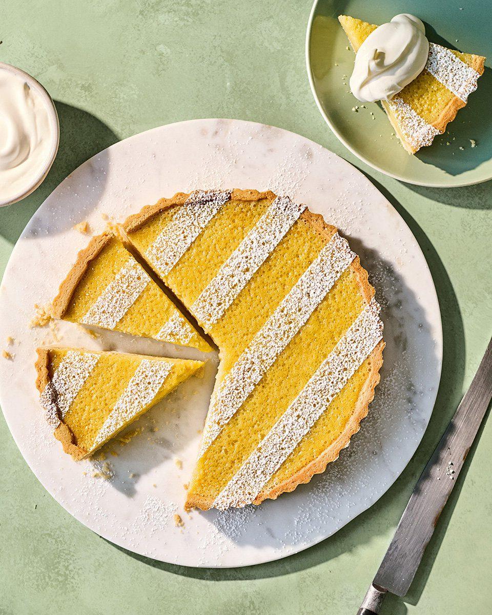 elderflower gooseberry tart with lemon zest, golden crust, and a slice being served