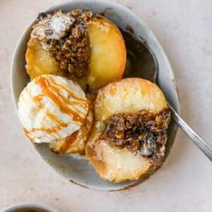 close up shot of apple cider baked apples with ice cream and cinnamon