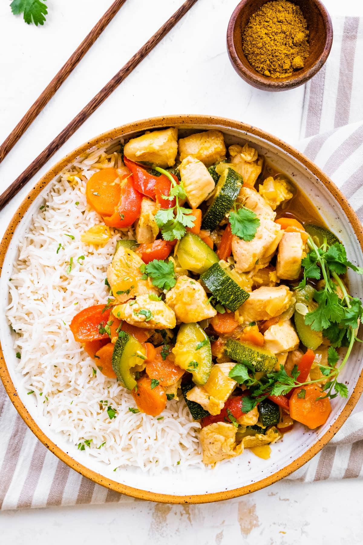 grilled chicken and vegetable curry with coconut milk served in a bowl