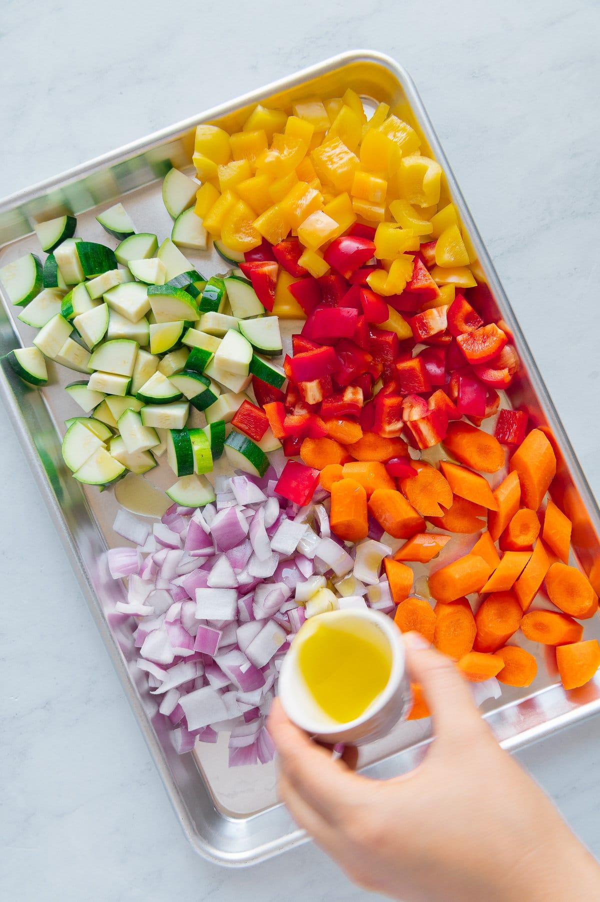 colorful array of roasted vegetables including bell peppers, zucchini, and red onion