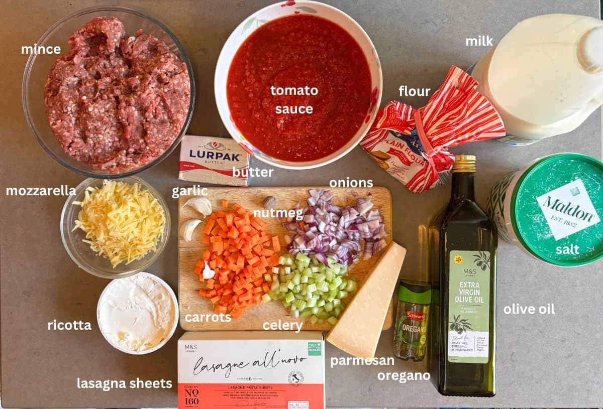 Ingredients for lasagna being laid out on a kitchen counter
